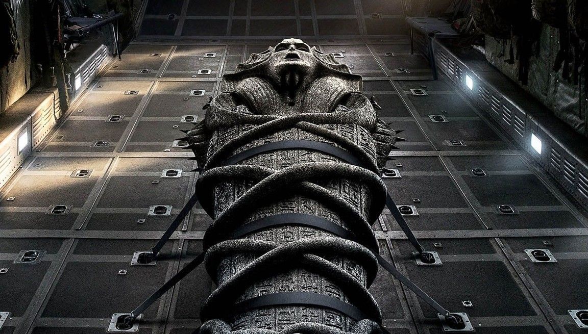 Ancient sarcophagus bound with straps inside a dimly lit chamber.