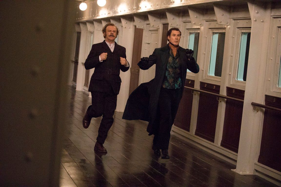Two men in period clothing run down a corridor with windows.