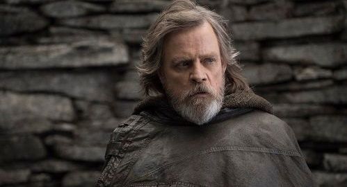 Mark Hamill as Luke Skywalker, weathered face, gray beard, outdoors, stone wall background.