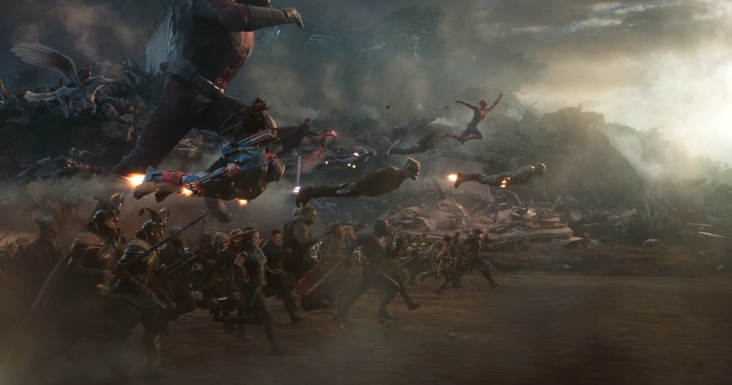 Superhero battle in a smoky, ruined city, with fighters charging amid debris and explosions