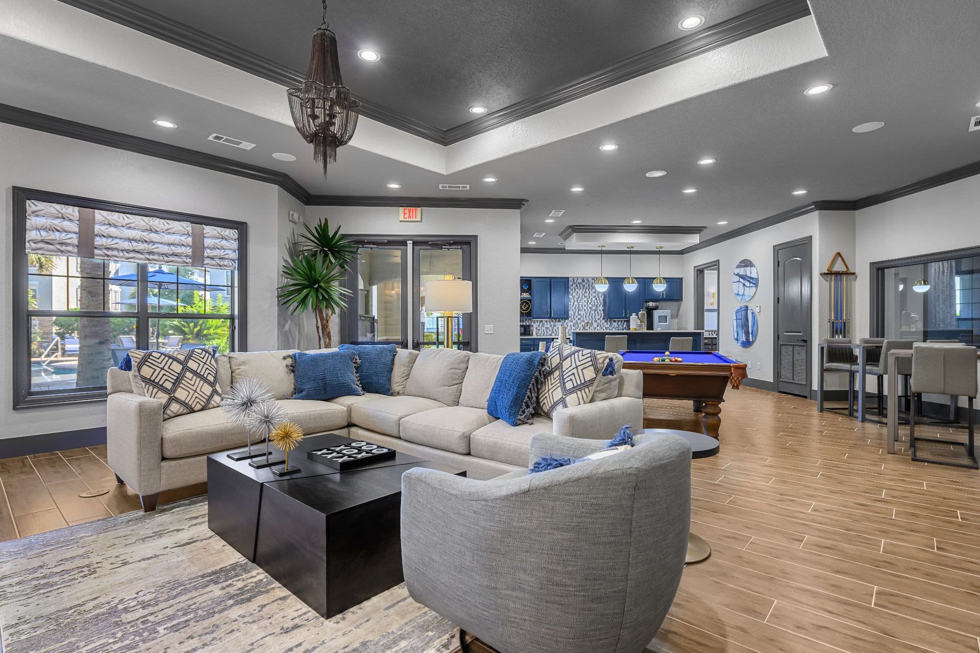 A living room filled with furniture and a pool table at Marquis Lakeline Station in Austin, TX.