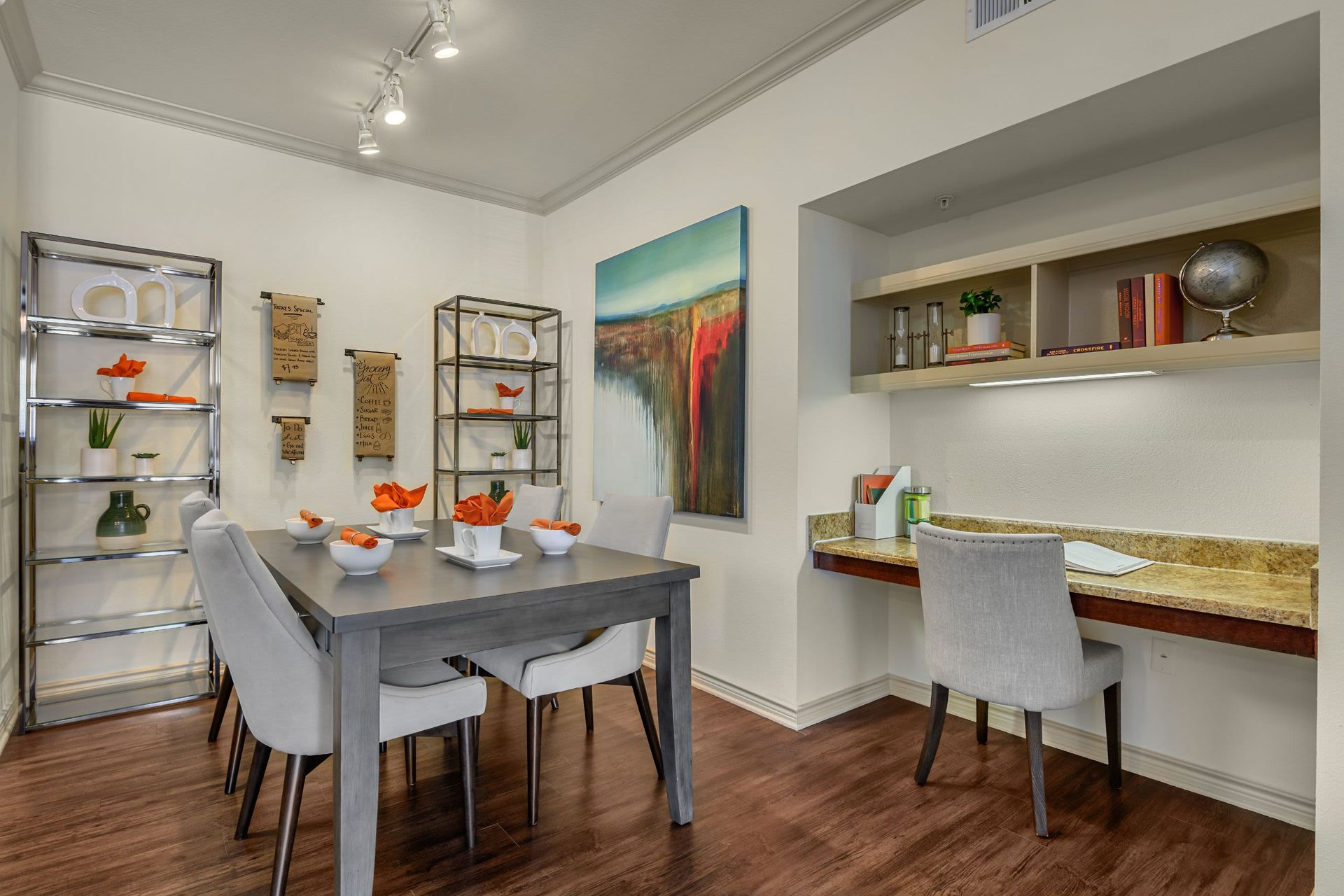 A dining room with a table and chairs and a desk at Marquis Lakeline Station in Austin, TX.