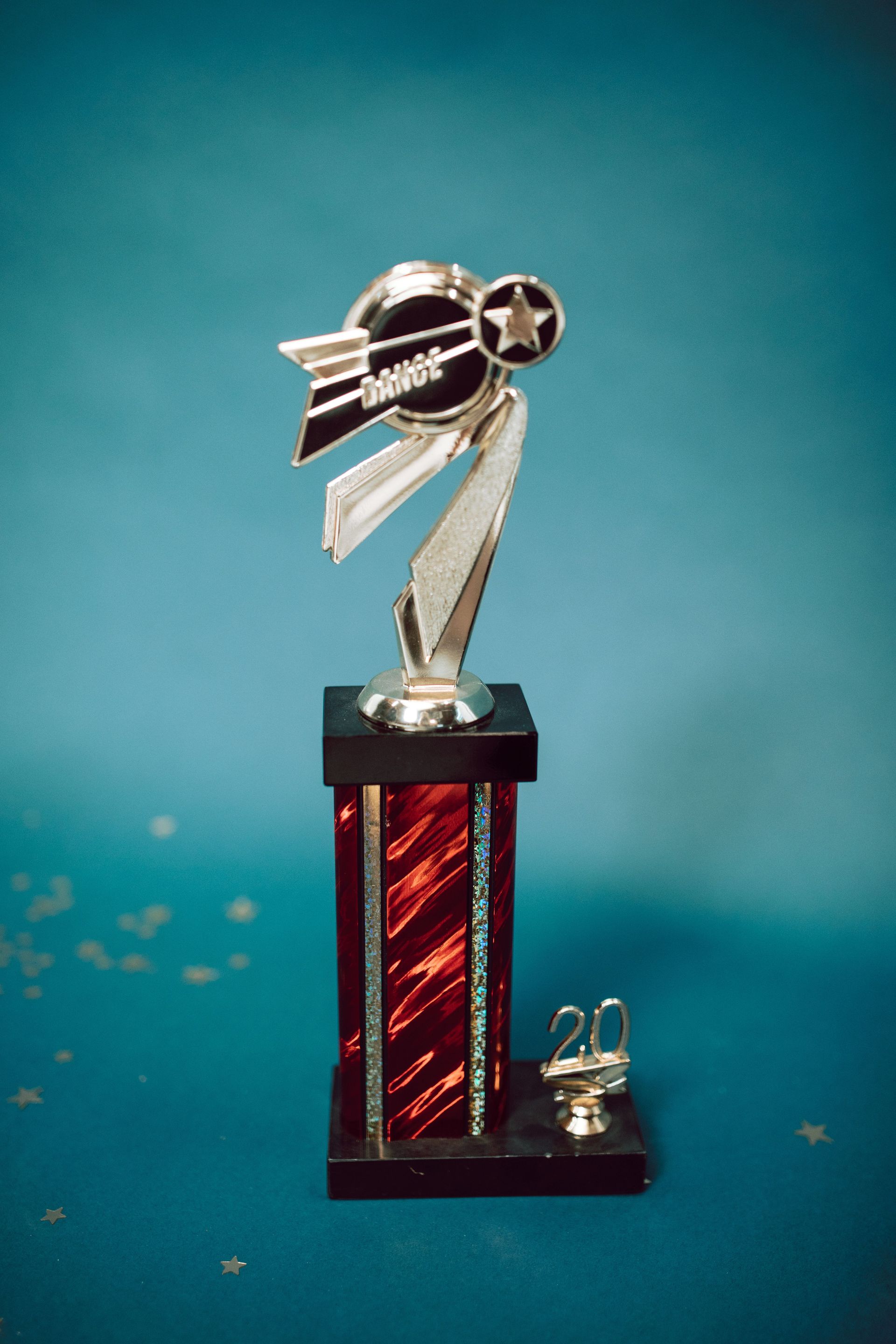 A gold trophy against a teal background