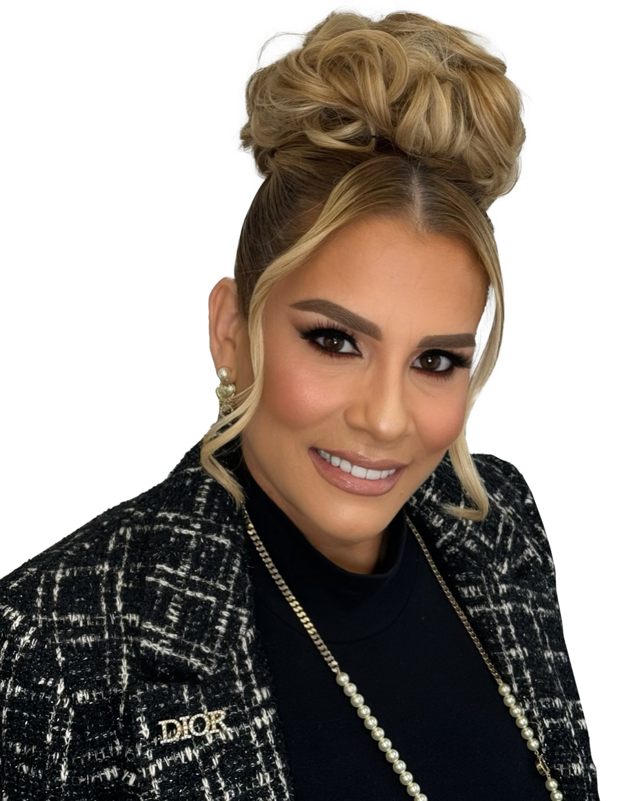 A woman wearing a black jacket with a dior brooch