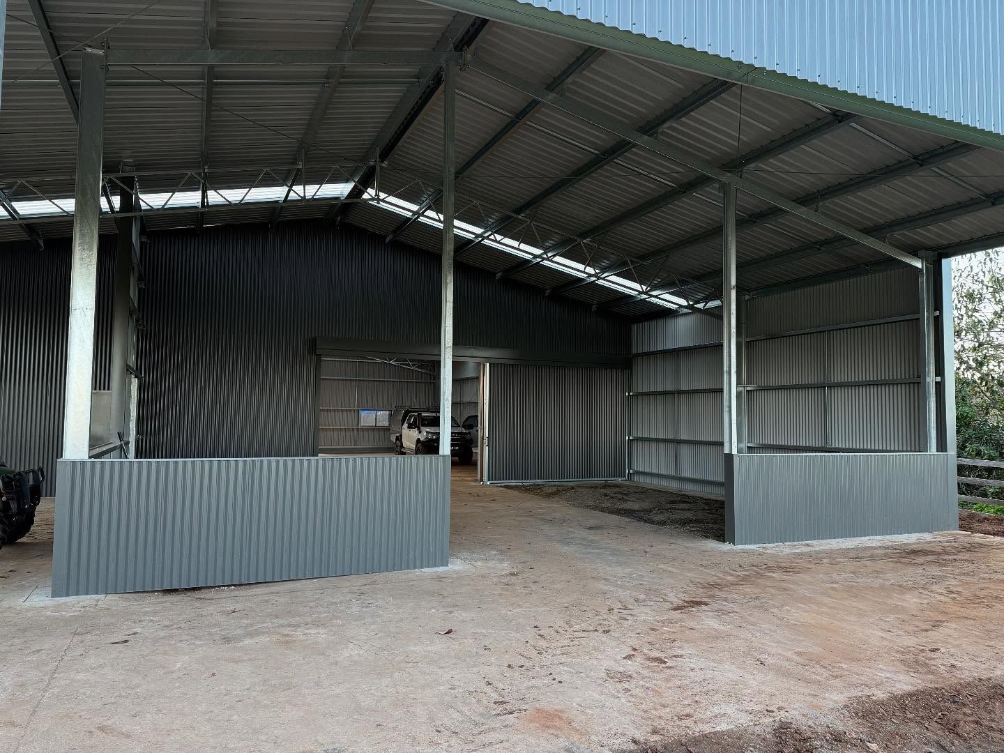 Metal shed with corrugated walls and roof, open front, dirt floor. — Equine Stable Solutions In Diddillibah, QLD