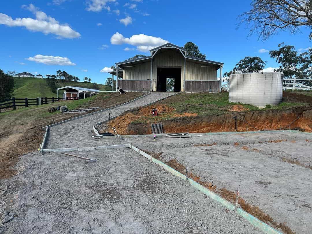 A Barn Is Being Built On Top Of A Dirt Hill — Equine Stable Solutions In Gold Coast, QLD