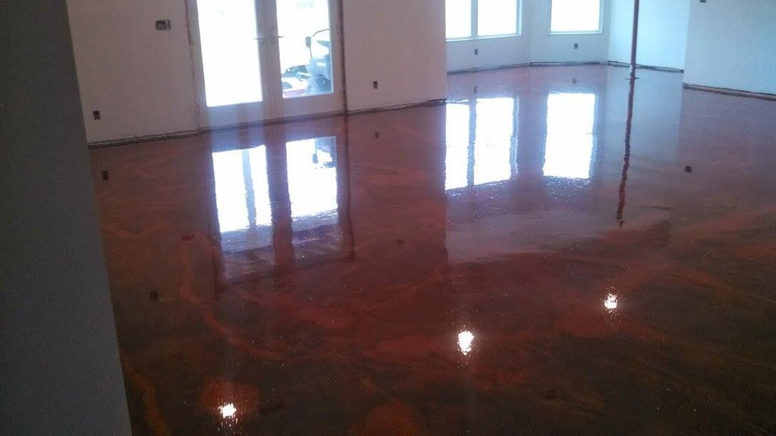 Empty room with glossy dark floor reflecting windows and doors