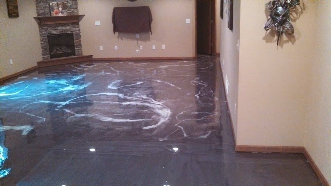 Living room with a wet floor covered in water reflections and a fireplace in the background