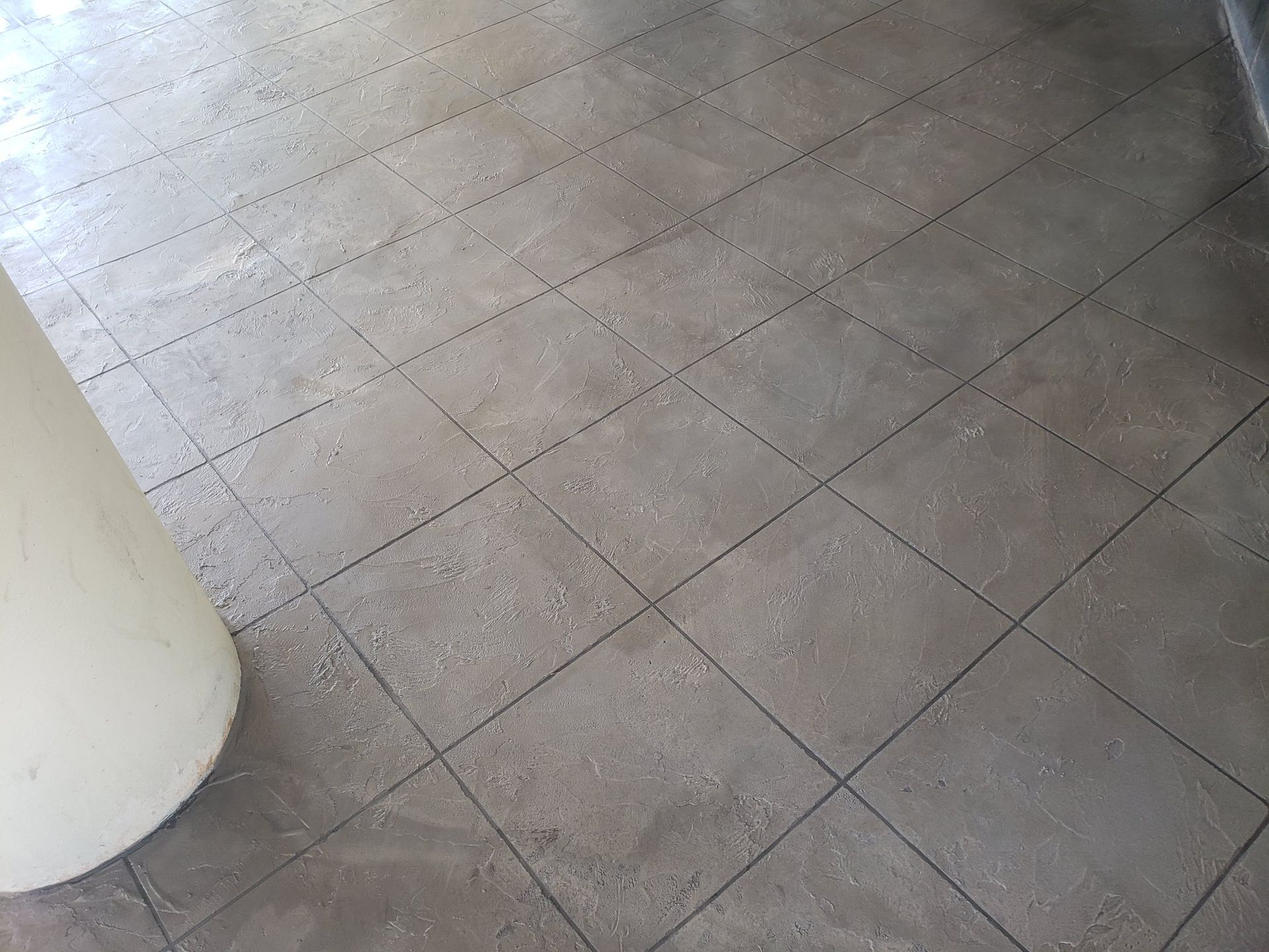 Tiled floor with a large white column on the left side
