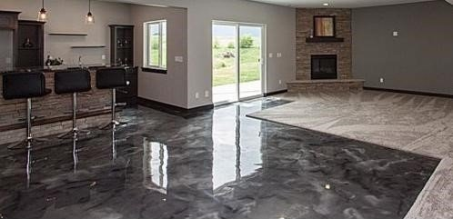 Empty living room with gray leather sofas and a glass coffee table on a light carpet.