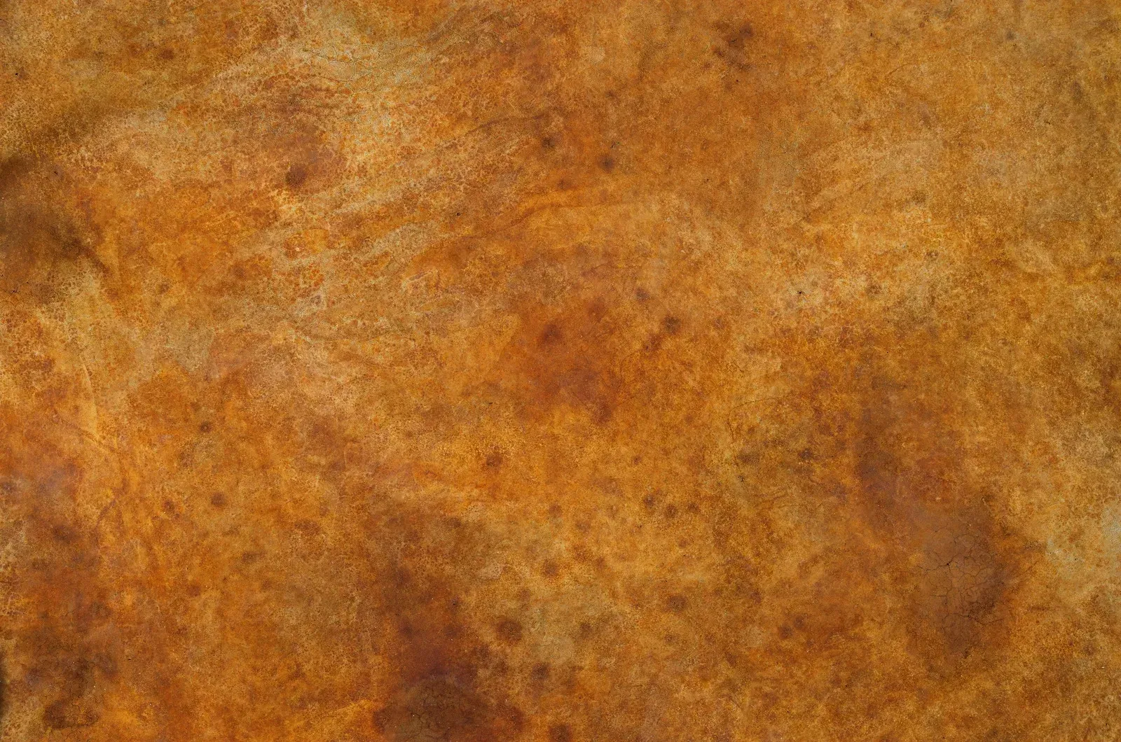 Orange-brown textured surface with mottled, earthy patterns