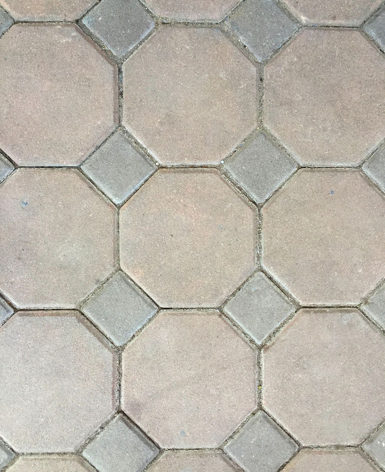 Interlocking gray and beige hexagonal paving stones forming a patterned walkway