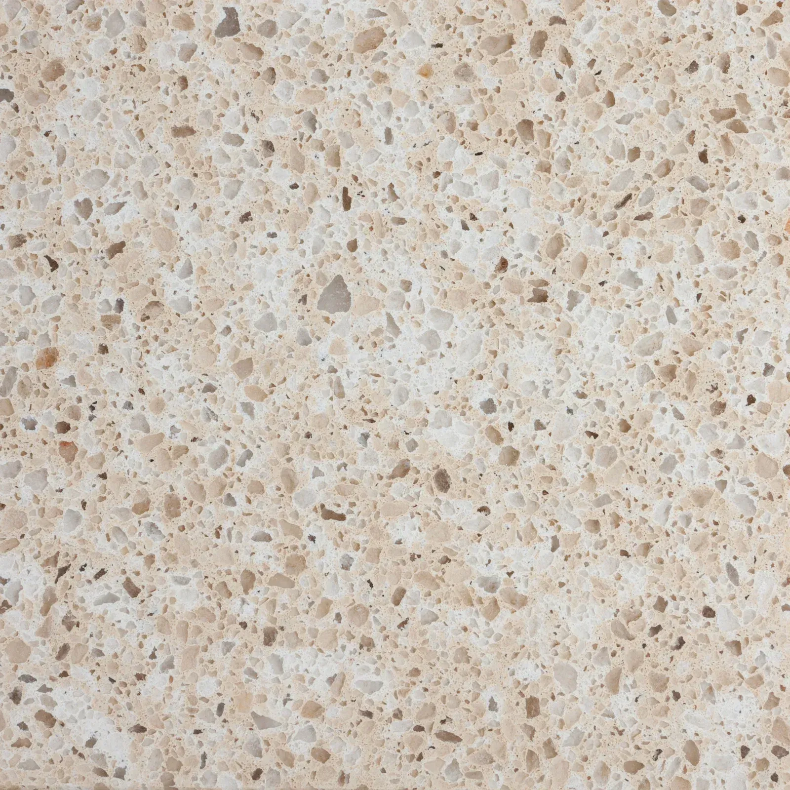 Light beige speckled stone or terrazzo surface with small gray and tan flecks