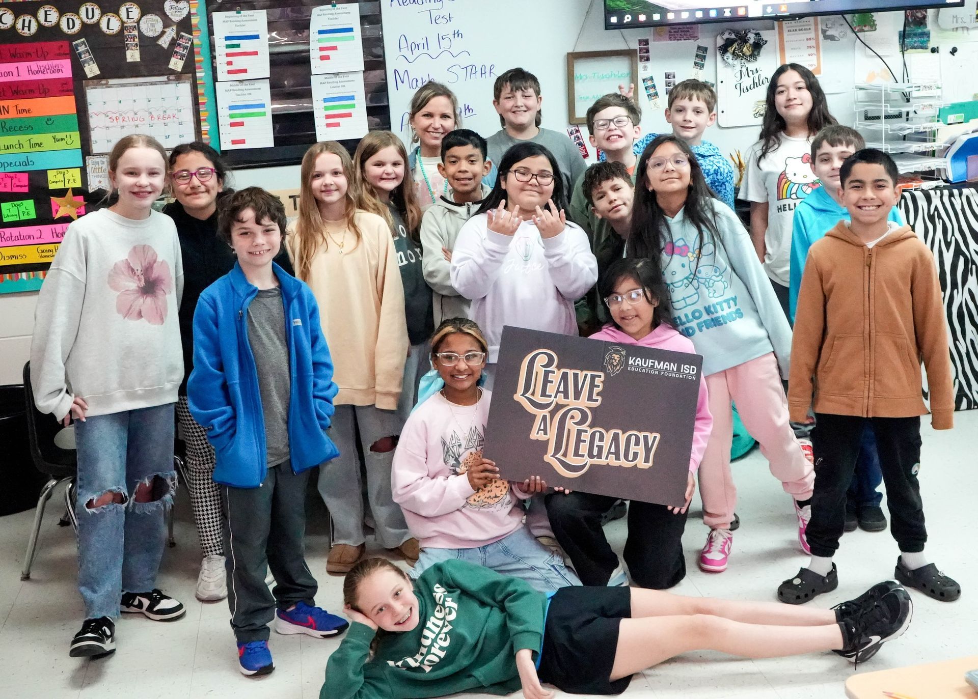 A group of children are posing for a picture in a classroom.