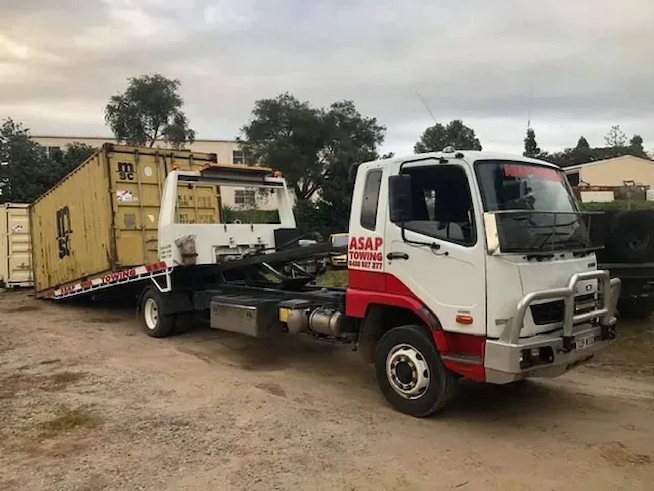 Flatbed Tow Truck Transporting a Yellow Shipping Container — ASAP Towing Pty Ltd In Tiaro, QLD
