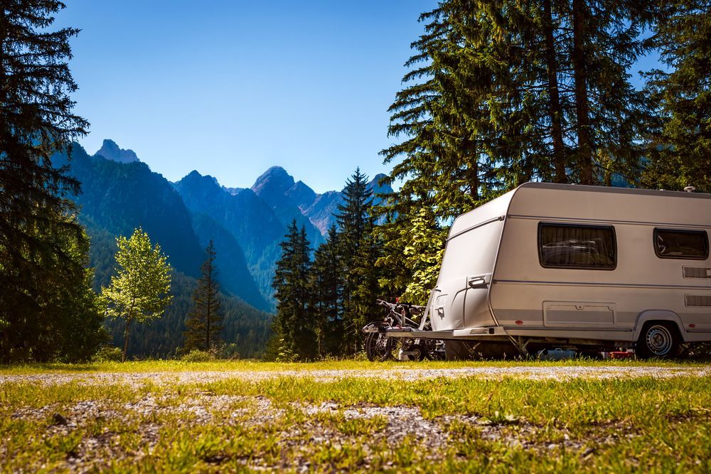 White Camper Trailer Parked on Grass — ASAP Towing Pty Ltd In Tin Can Bay, QLD