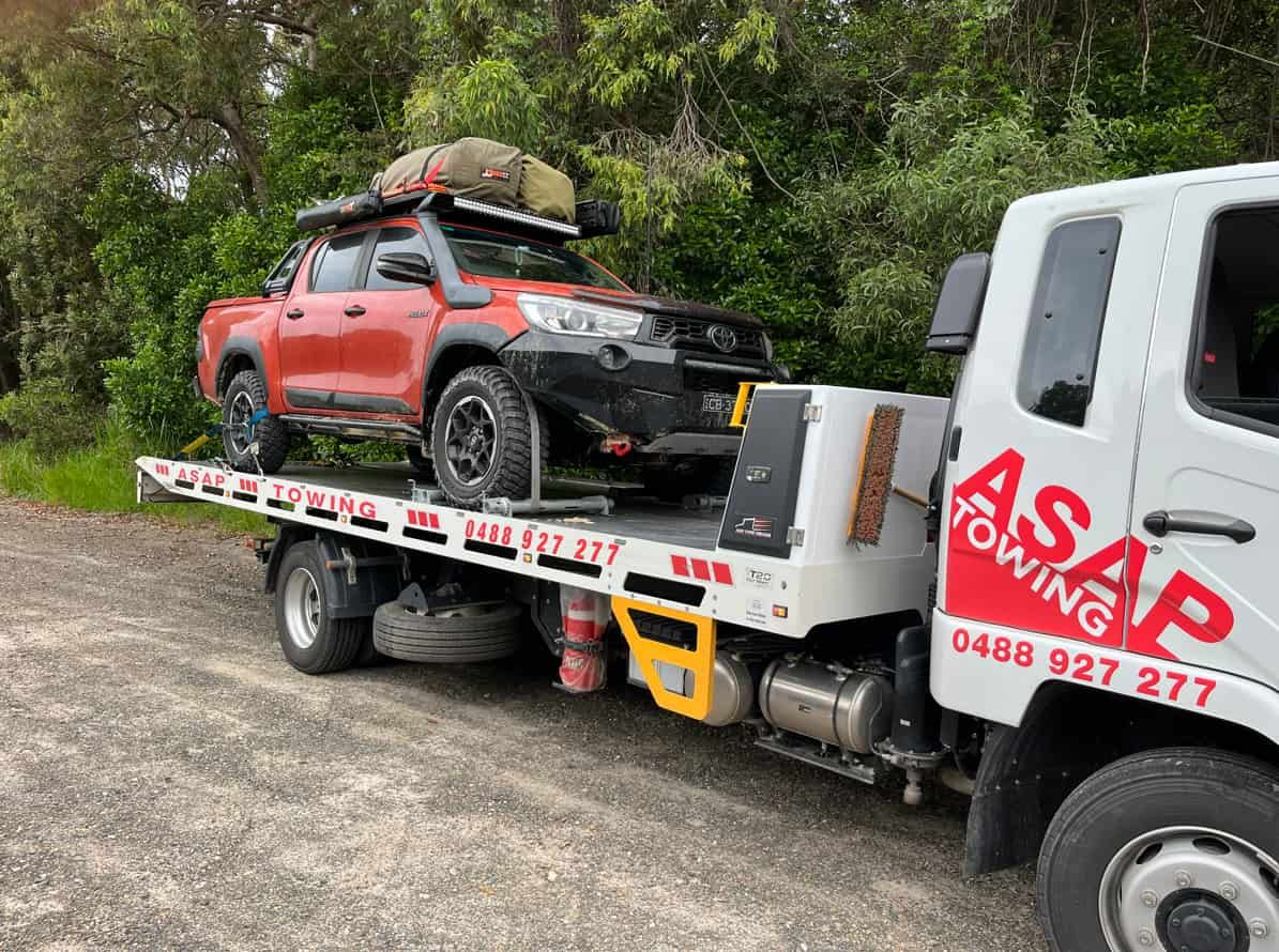 Red Off-road Truck Loaded on a White Tow Truck — ASAP Towing Pty Ltd In Gympie, QLD