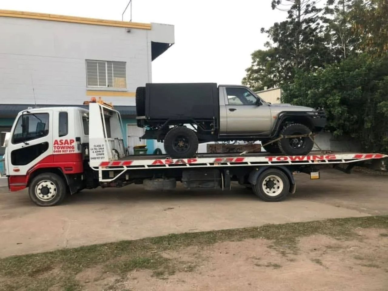 Tow Truck Carrying a Silver Pickup Truck — ASAP Towing Pty Ltd In Gympie, QLD