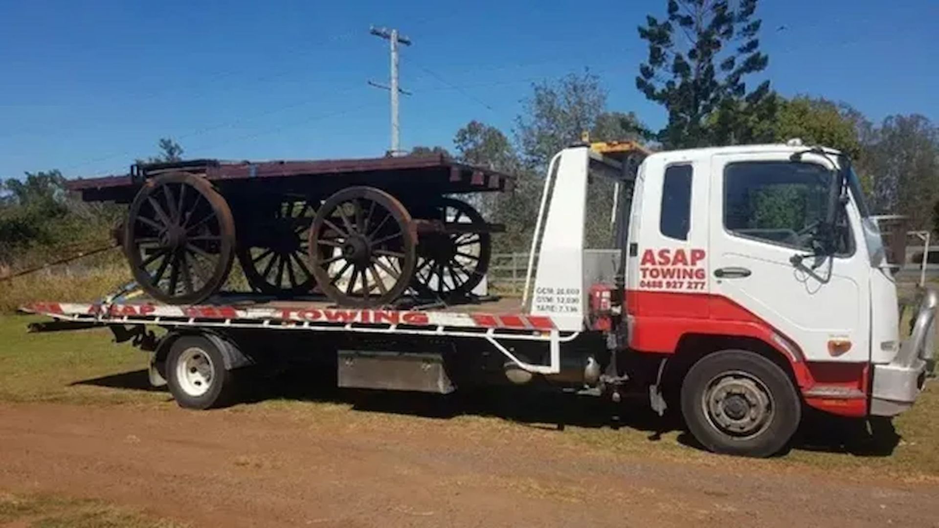 Flatbed Truck Transporting a Grey, Modular Building — ASAP Towing Pty Ltd In Gympie, QLD