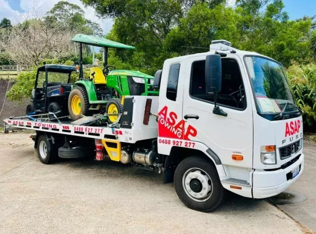 Flatbed Truck Transporting a Grey, Modular Building — ASAP Towing Pty Ltd In Gympie, QLD