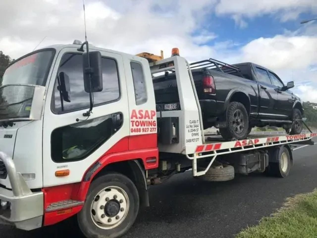 Tow Truck With a Black Pickup Truck on Its Flatbed — ASAP Towing Pty Ltd In Gympie, QLD