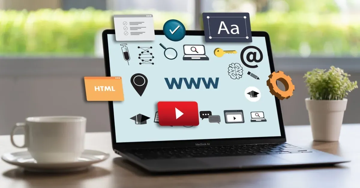 Laptop with website icons, coffee cup, and a plant on a desk.
