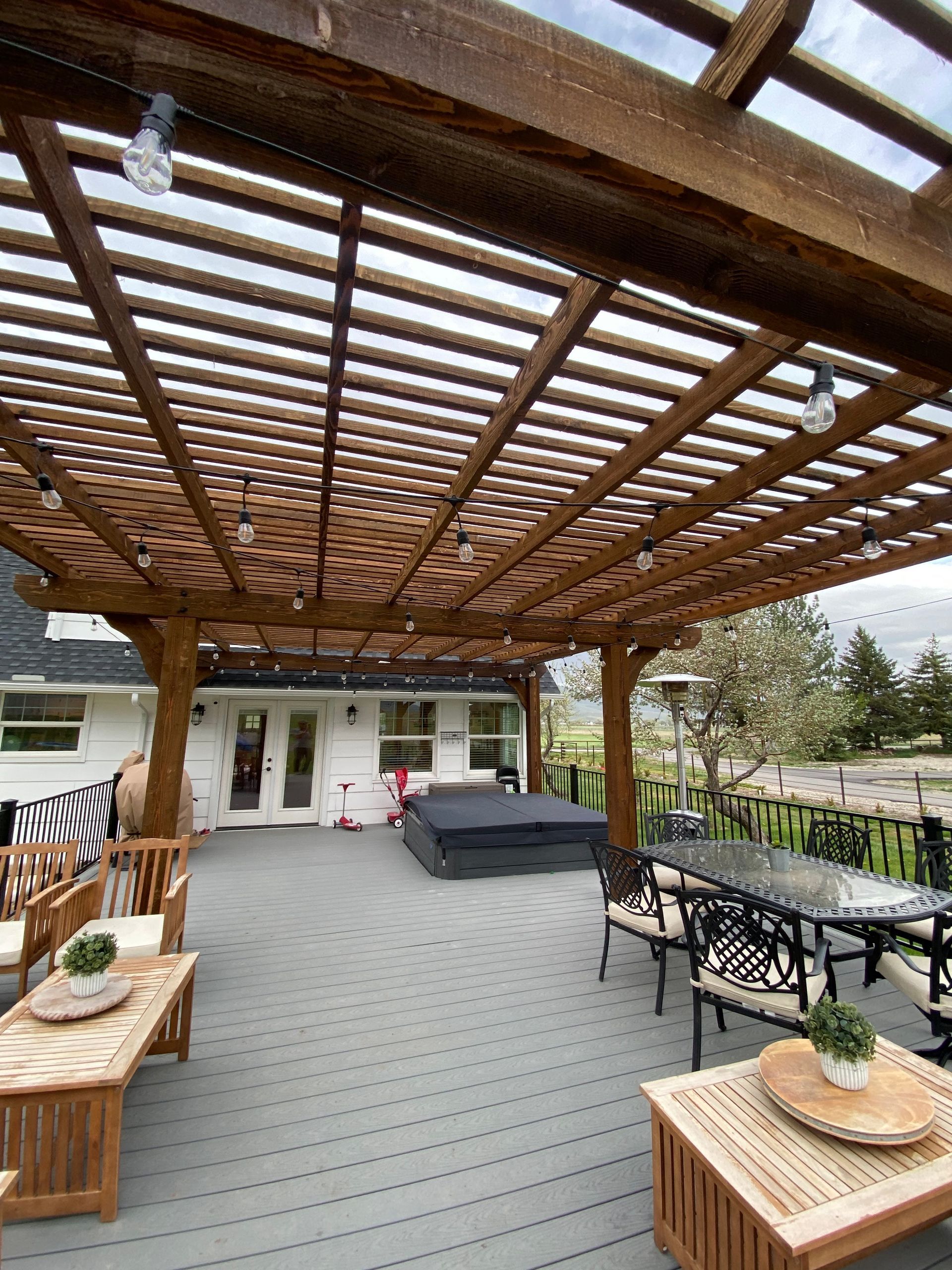 a man is standing on a ladder painting a gazebo .