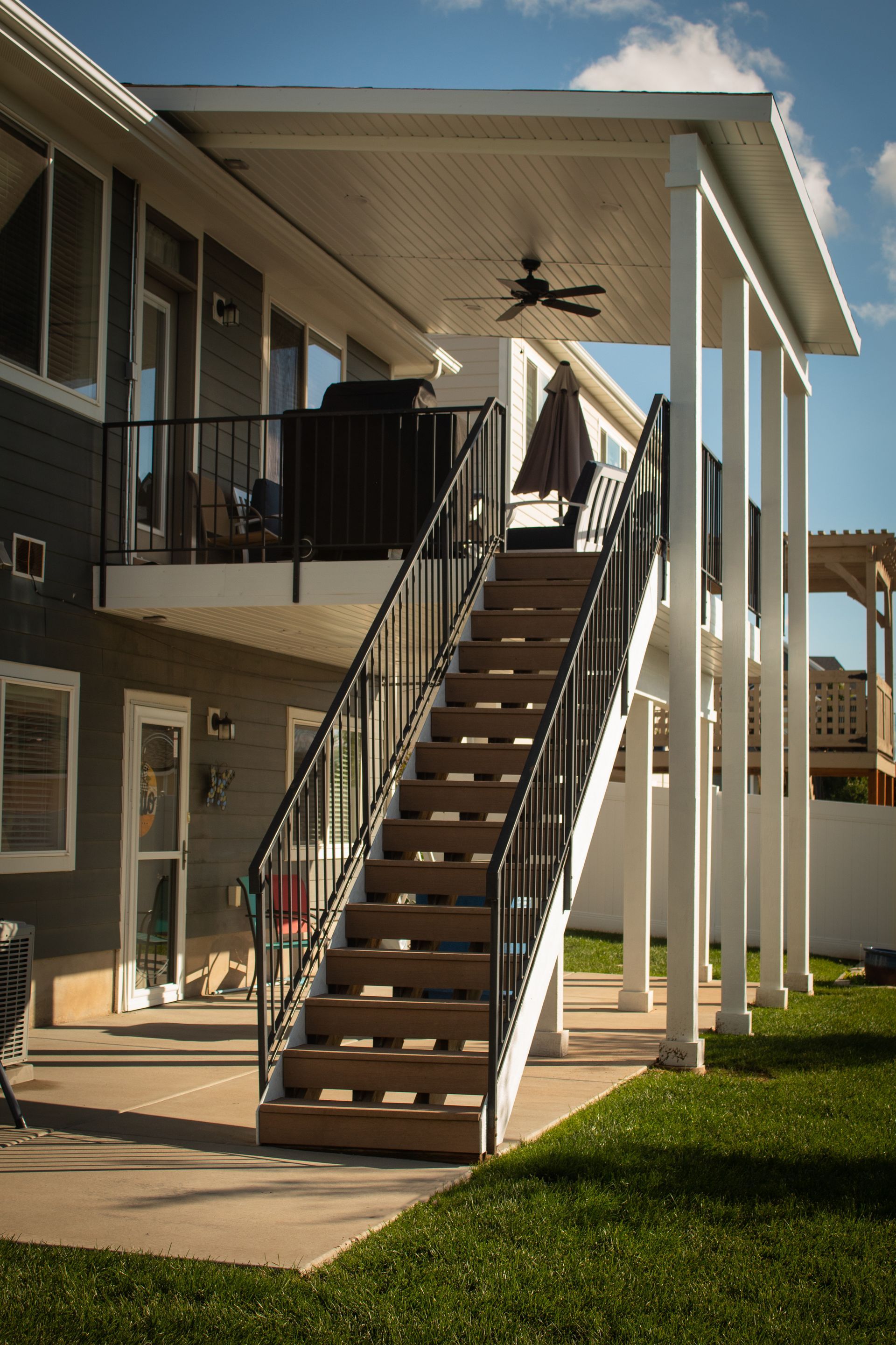 A house with a balcony and stairs leading up to it