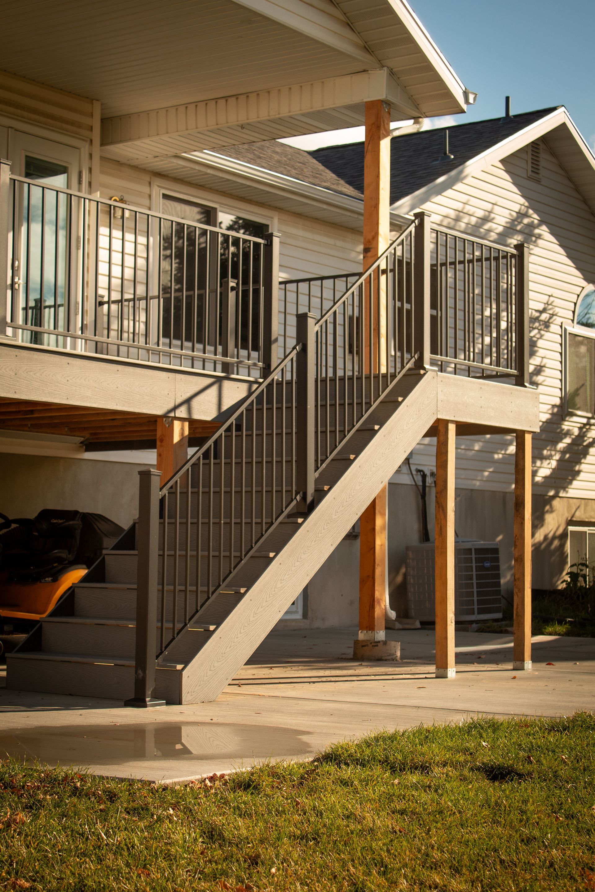 A staircase leading up to a deck of a house.