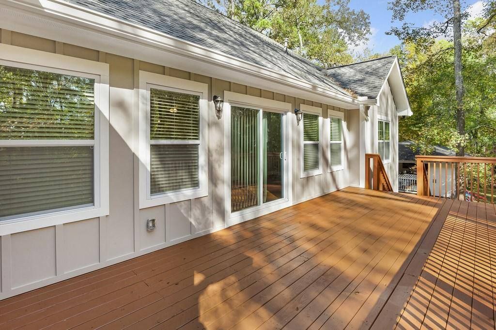 A house with a large wooden deck in front of it