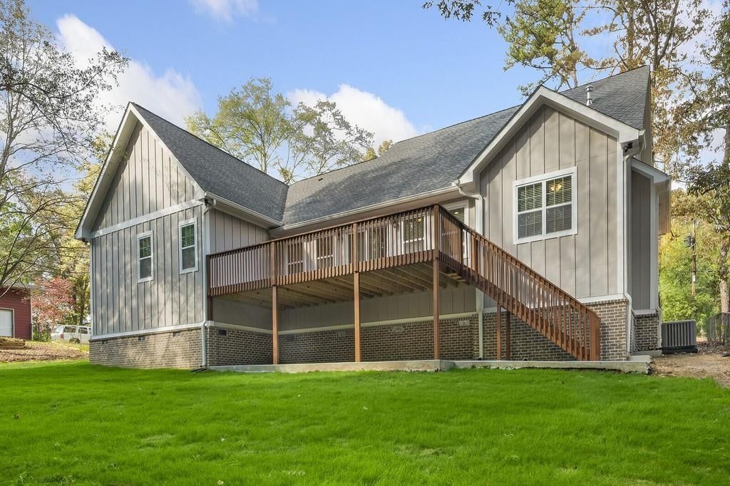 A large house with a large deck and stairs
