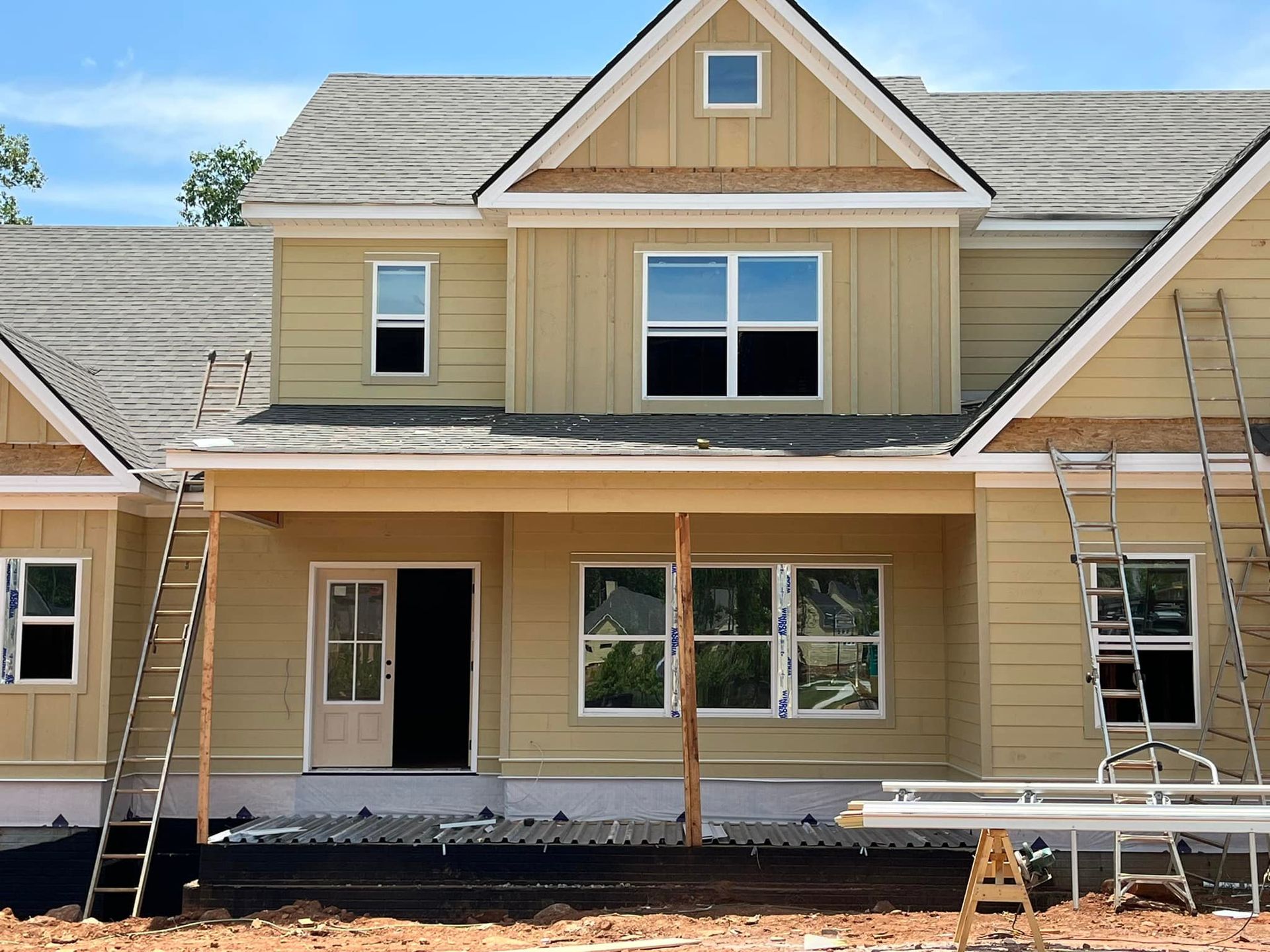 A house that is being built with a lot of windows