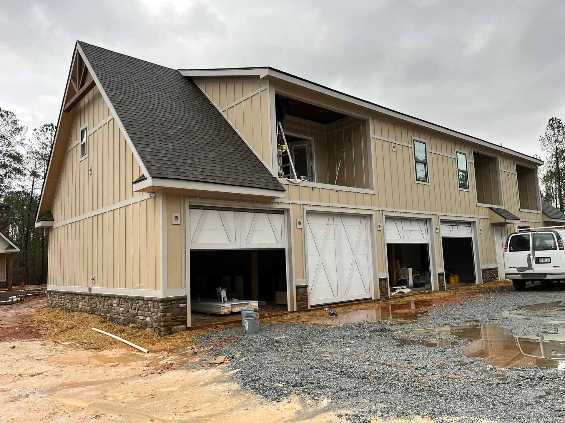 A house under construction with a truck parked in front of it