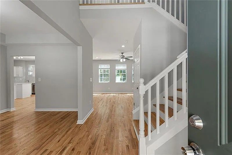 A picture of a house with hardwood floors and stairs.