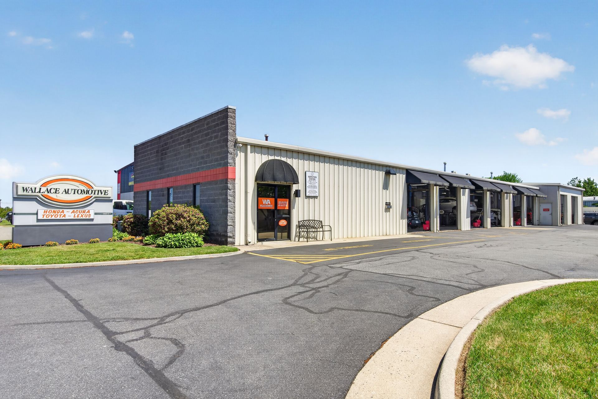 Outside of our shop with our Logo on a sign | Wallace Automotive Inc