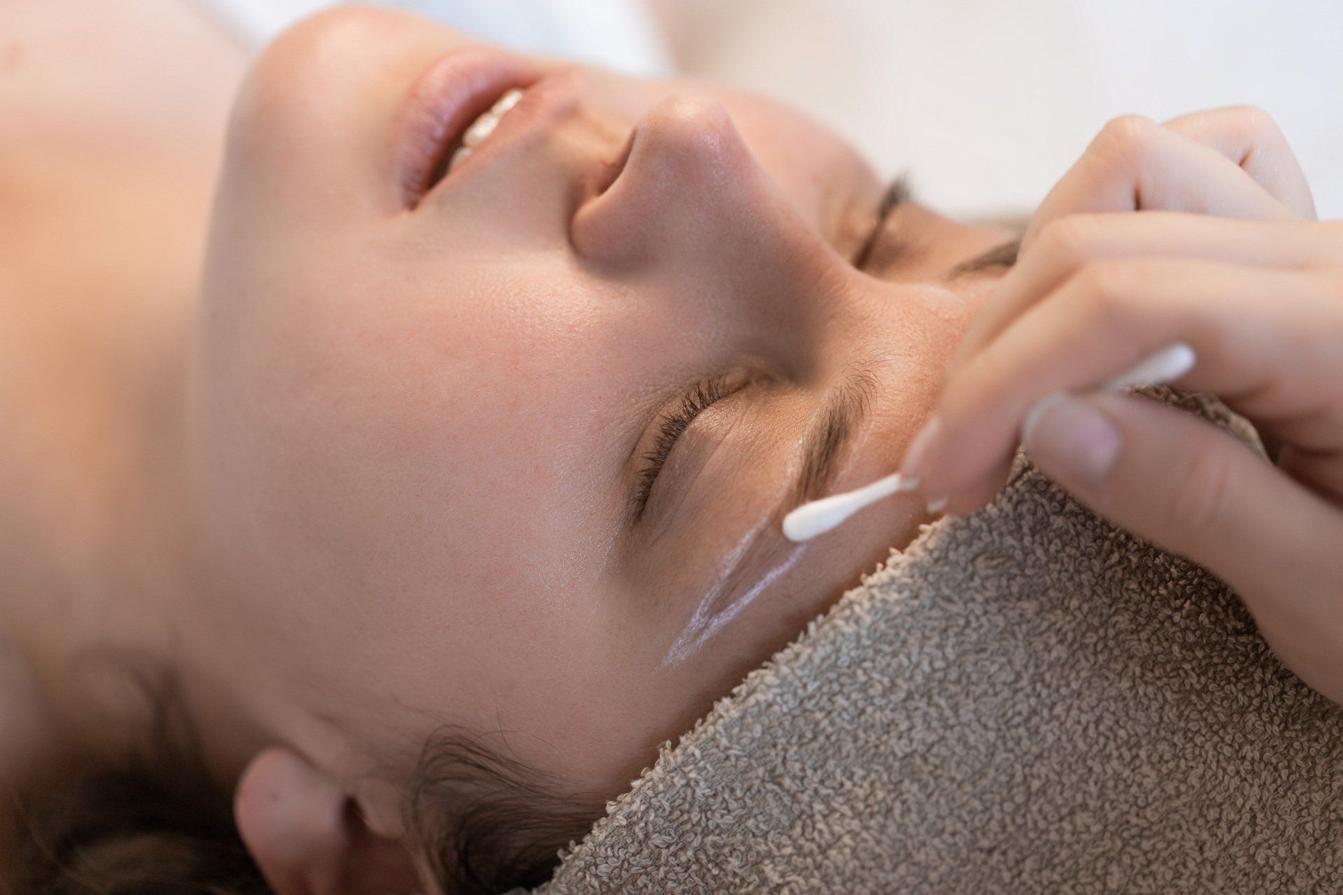 A woman is getting a facial treatment at a spa.