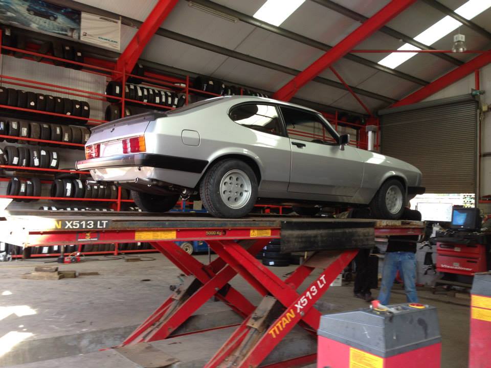 image of silver car on lift