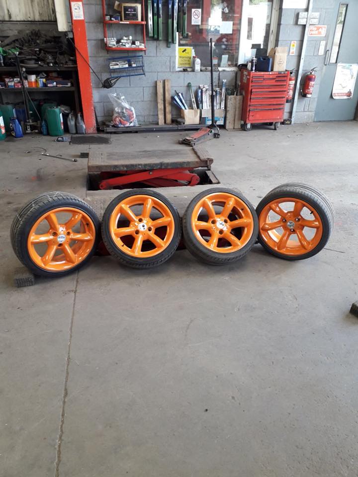 image of orange alloys with tires on