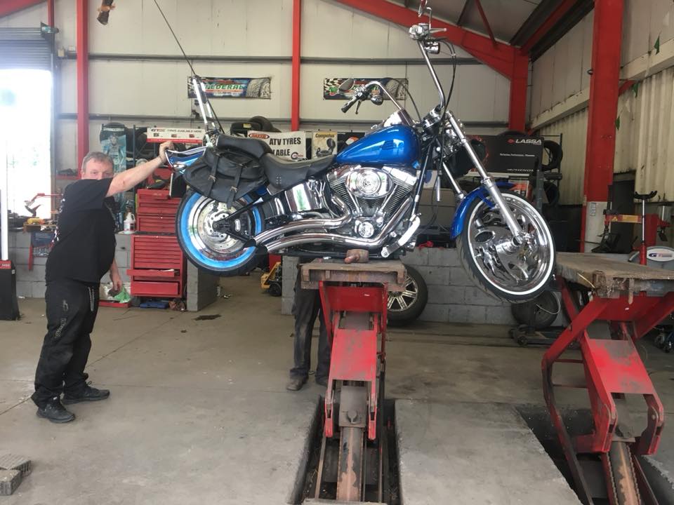 Blue motorbike getting worked on