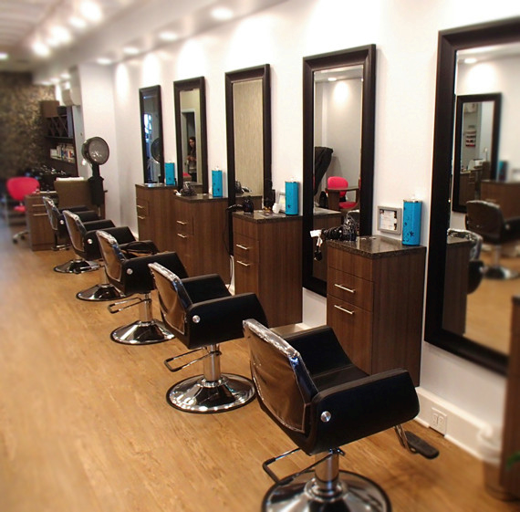 A row of chairs and mirrors in a hair salon