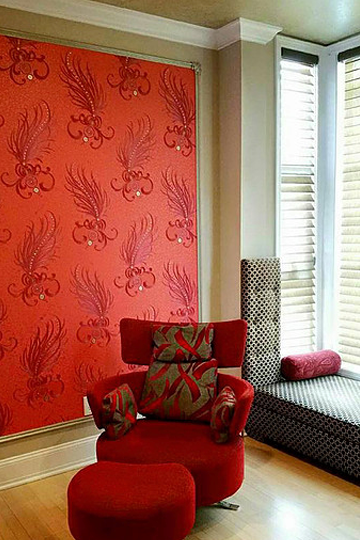 A living room with a red chair and ottoman