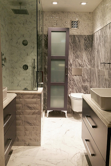 A bathroom with a toilet , sink and shower.