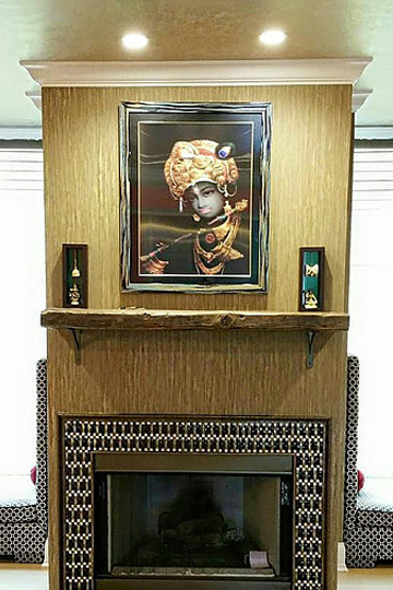 A fireplace with a painting on the wall above it.