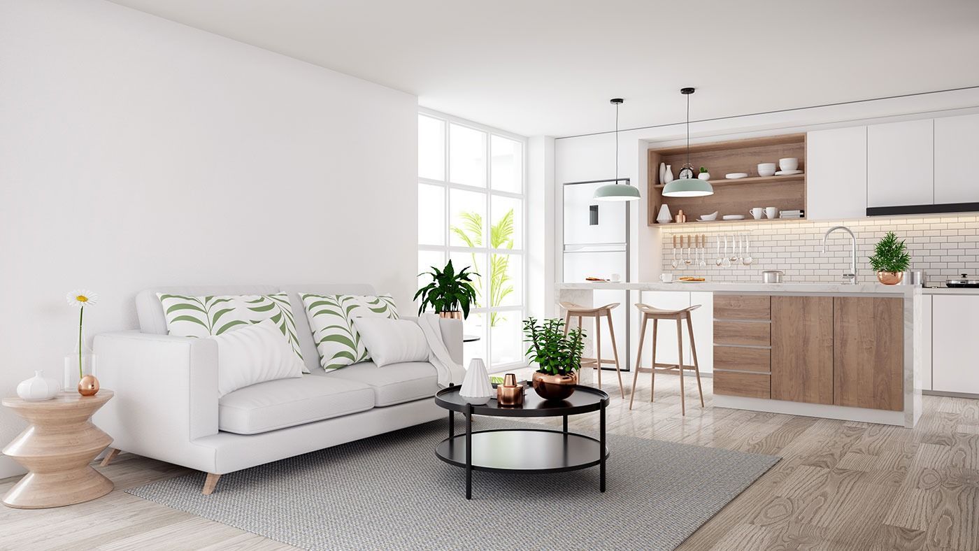 A living room with a white couch and a coffee table.