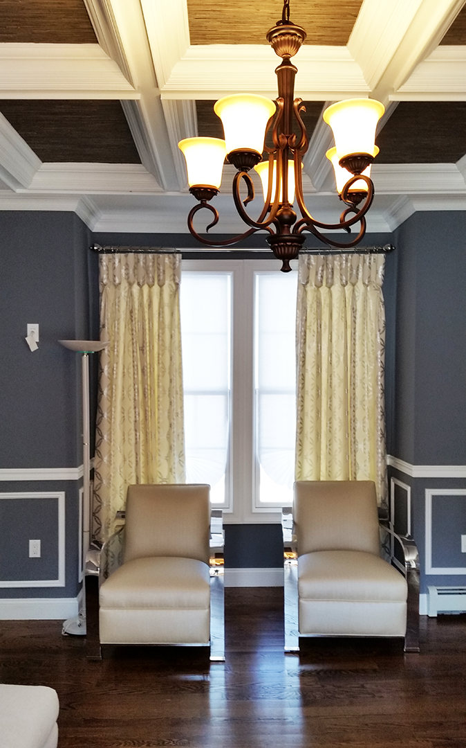 A living room with two chairs and a chandelier