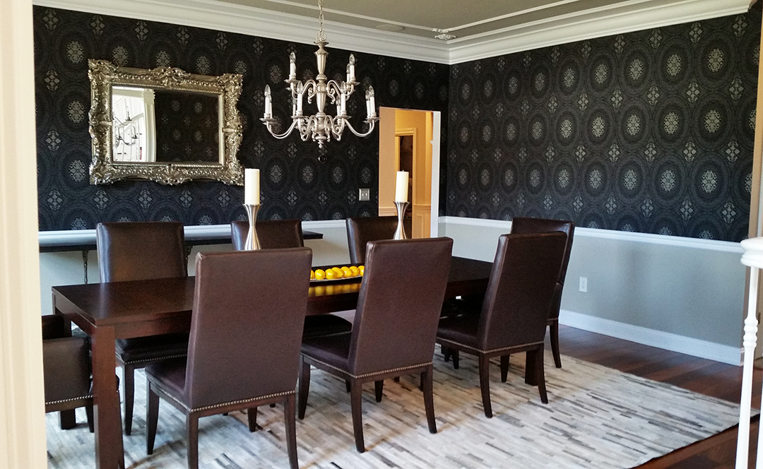 A dining room with a table and chairs and a chandelier