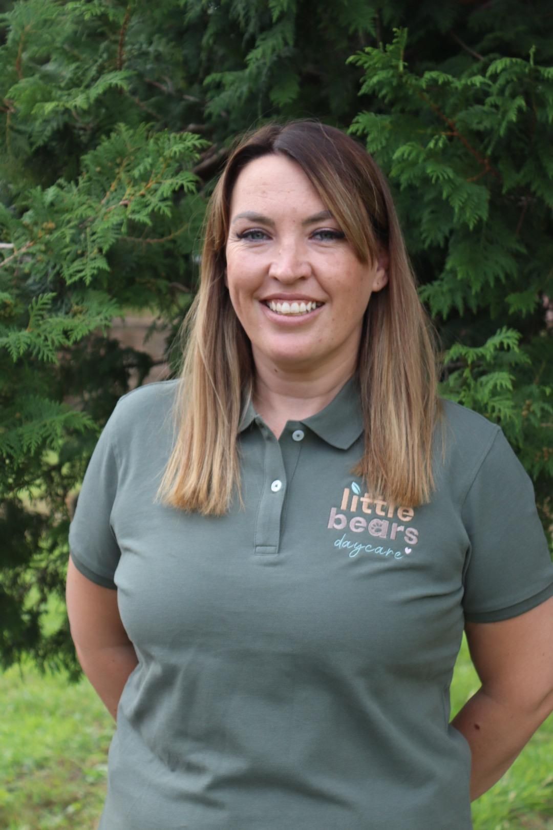 Woman wearing green polo shirt with 