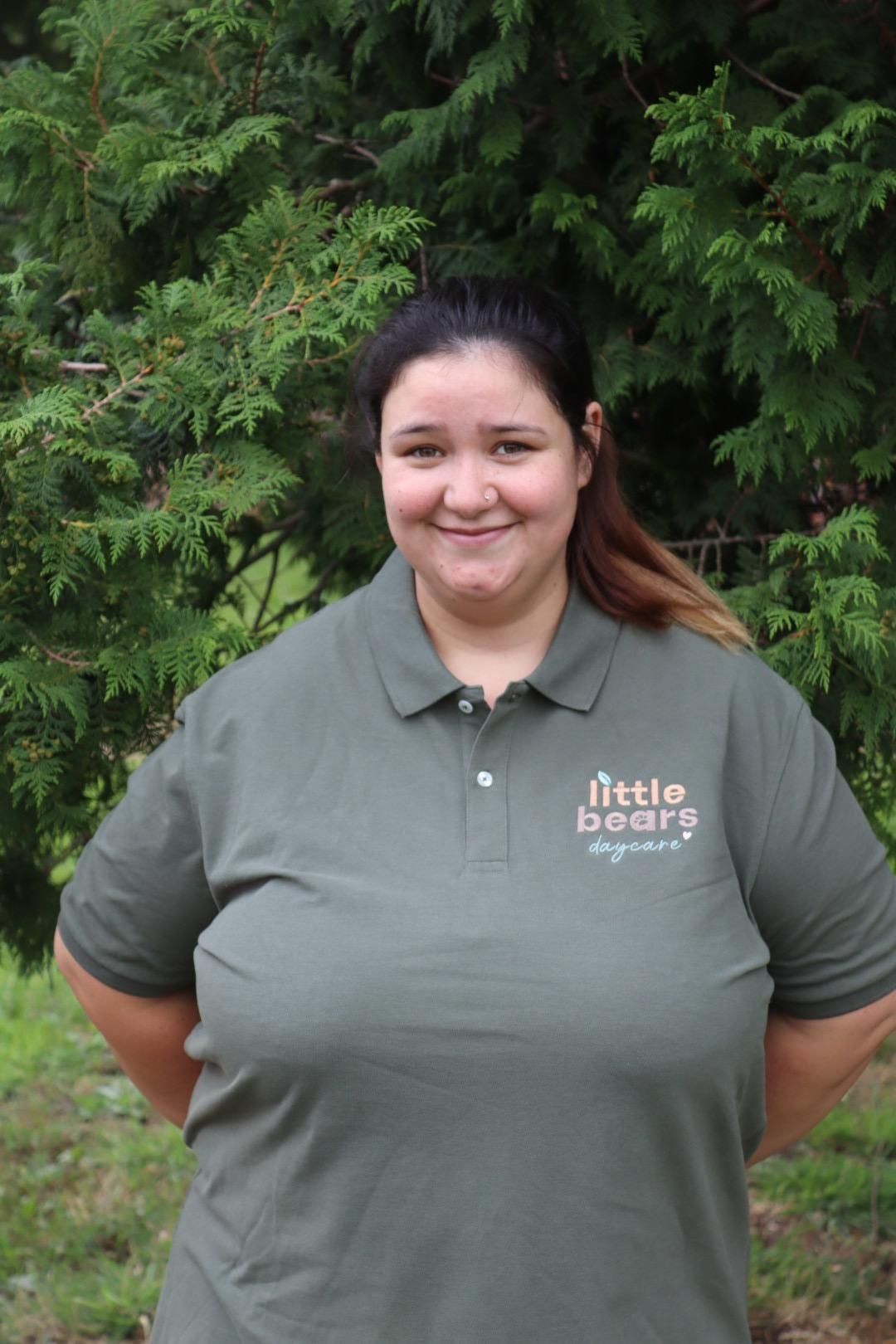 Woman wearing green polo shirt with 