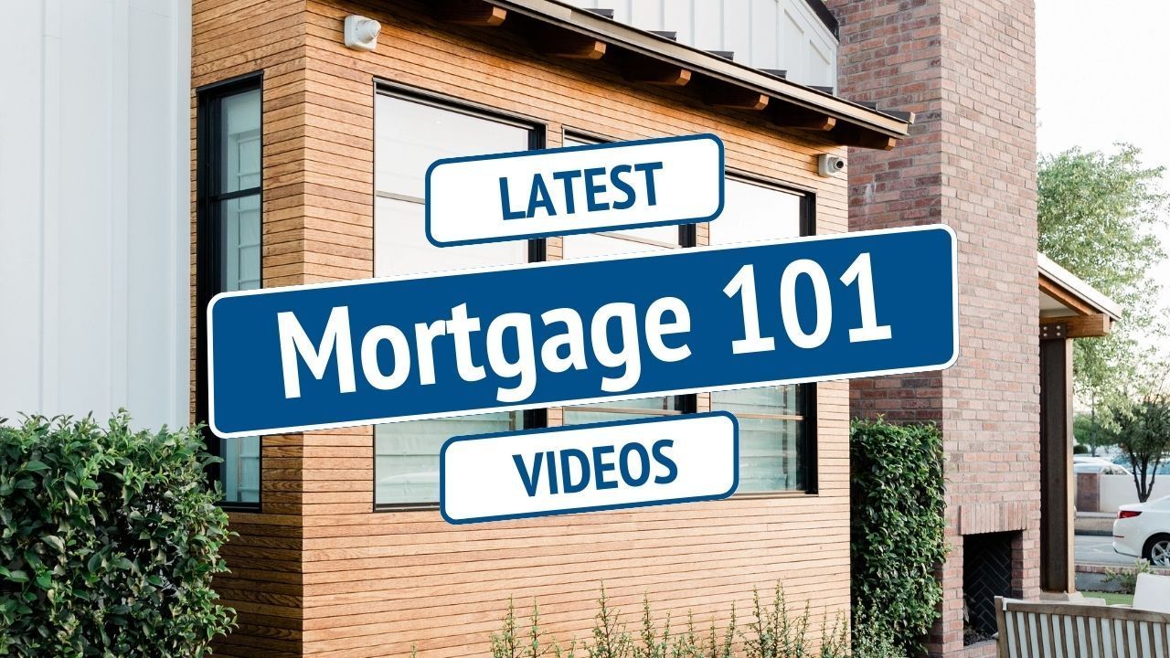 Blue sign reading “Mortgage 101” with “Latest” and “Videos” on a brick building outside.