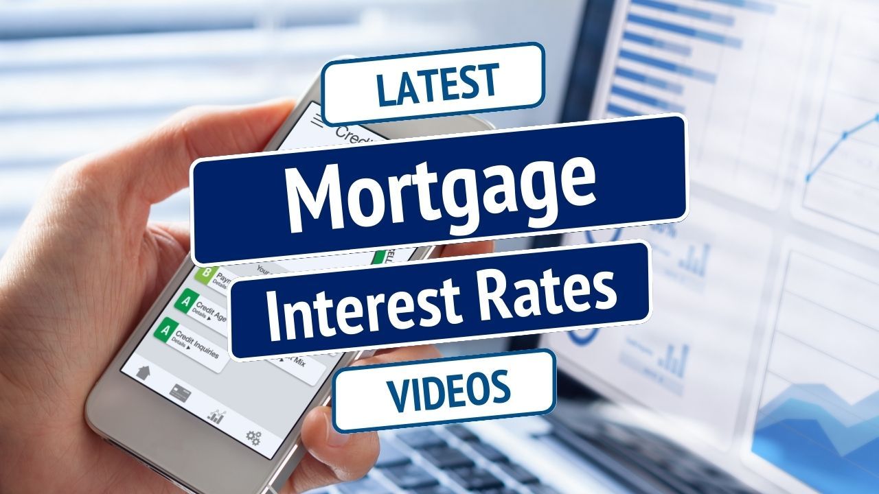 Hand holding smartphone with banner reading “Mortgage Interest Rates” and “Latest Videos”